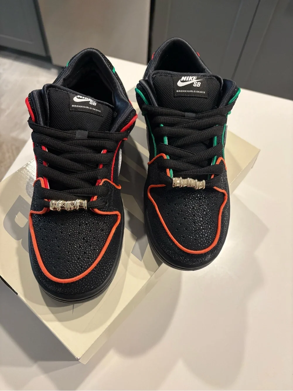 Nike Men’s Black Sneakers with White Swoosh and Orange/Red Trim